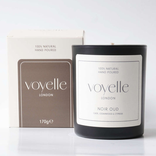Voyelle London Noir Oud candle in black glass with packaging box, labeled as 100% natural and hand poured