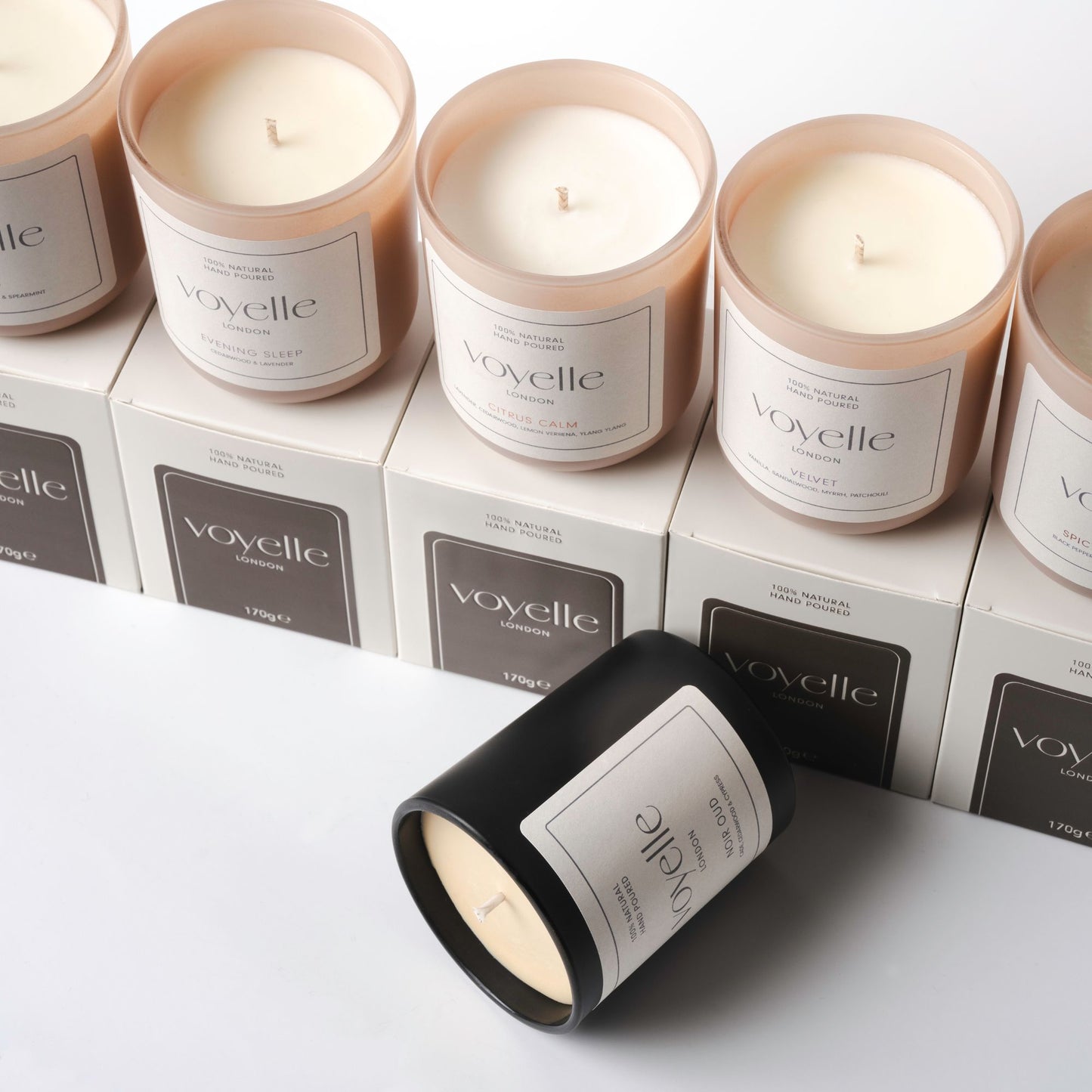 Multiple Voyelle candles in various scents displayed on top of their boxes