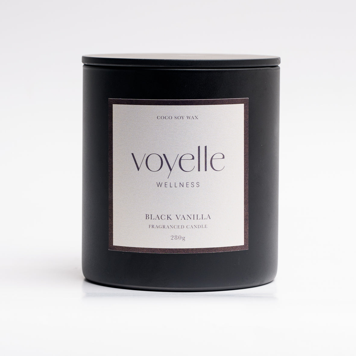 Black Vanilla candle lit in a cosy evening scene — sweet tobacco & vanilla