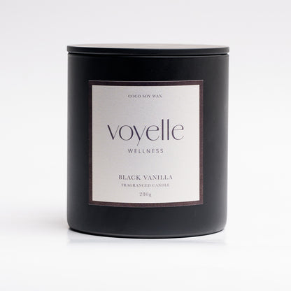 Black Vanilla candle lit in a cosy evening scene — sweet tobacco & vanilla