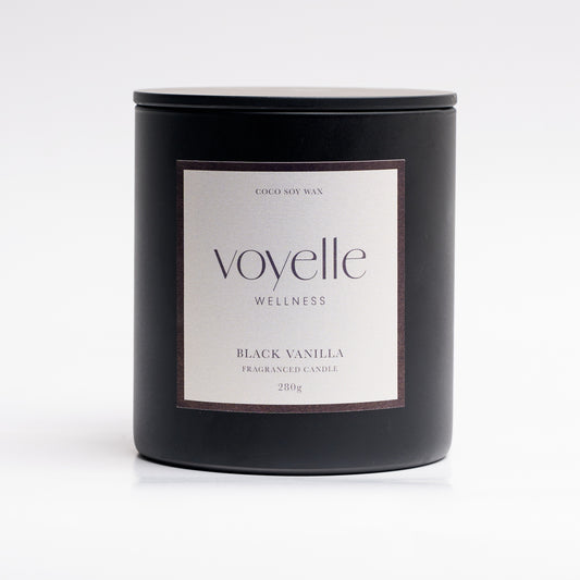 Black Vanilla candle lit in a cosy evening scene — sweet tobacco & vanilla