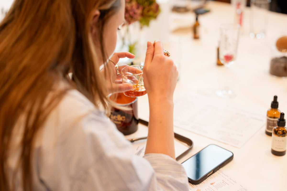 Blending a personal scent from pure essential oils at a Voyelle candle making workshop