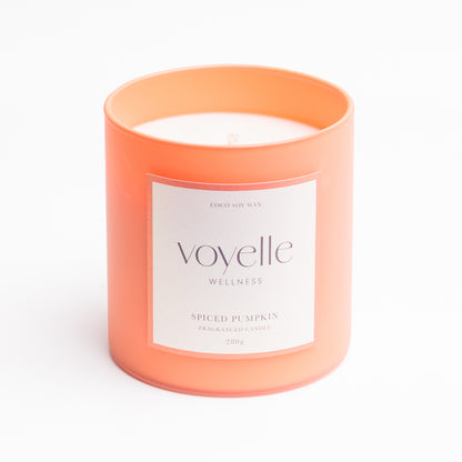 Spiced Pumpkin frosted coral glass candle with front label, studio portrait