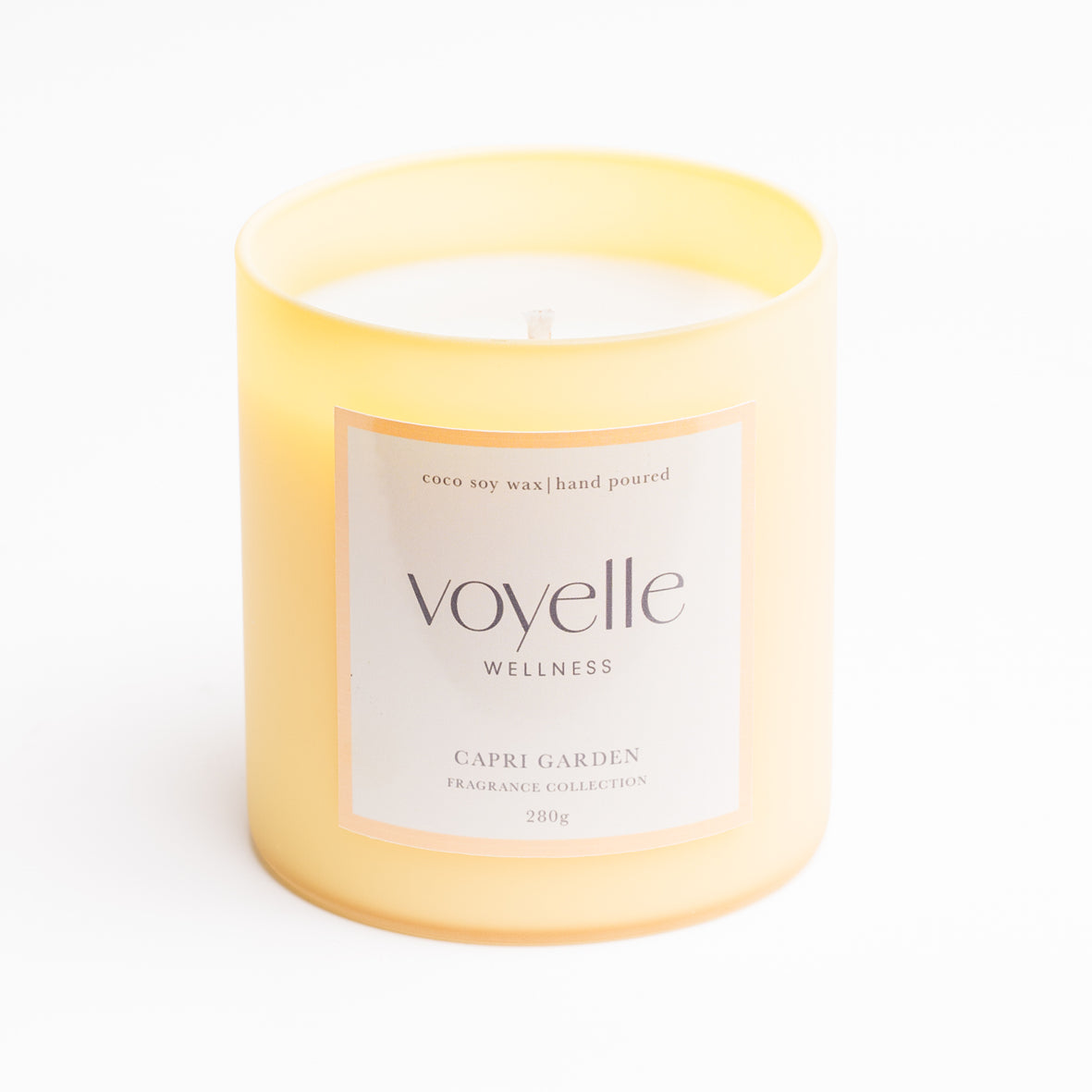 Capri Garden frosted yellow glass candle with front label, studio portrait
