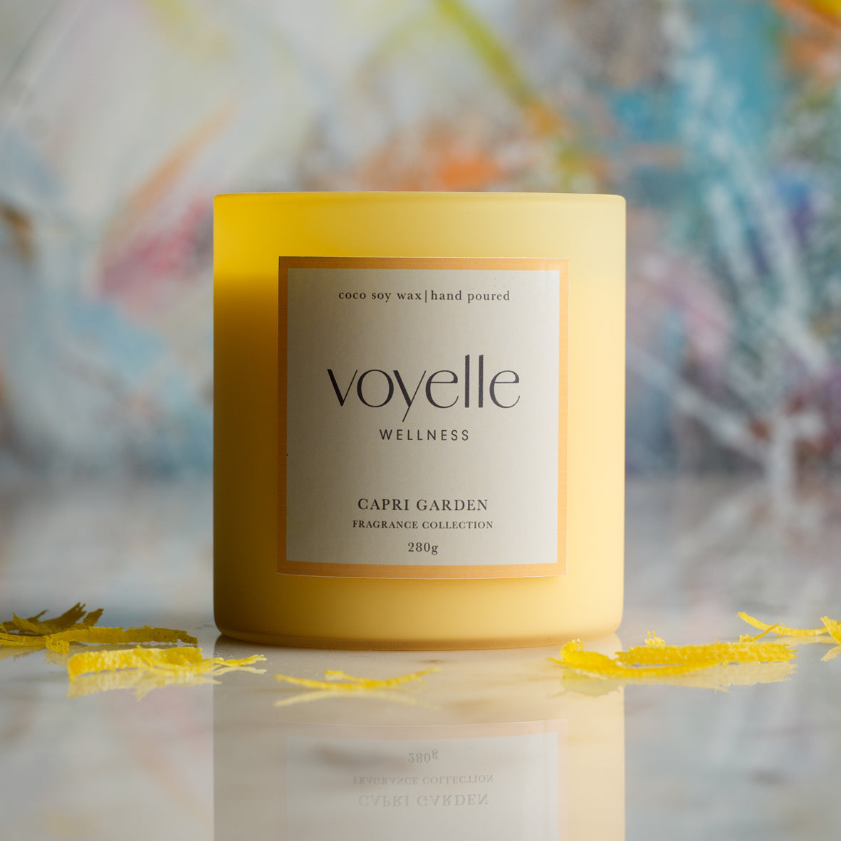 Capri Garden candle on marble with lemon zest, painterly background