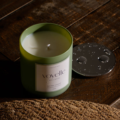 Azure Coast candle open on dark wood, its chrome lid beside