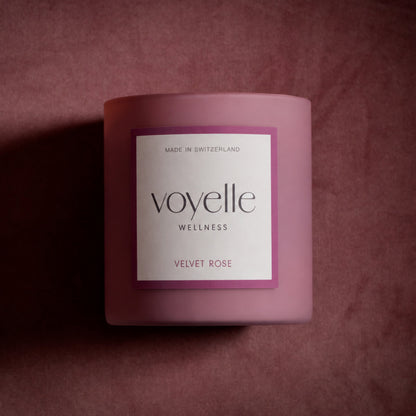 Velvet Rose candle on dusty-rose velvet in dramatic side light