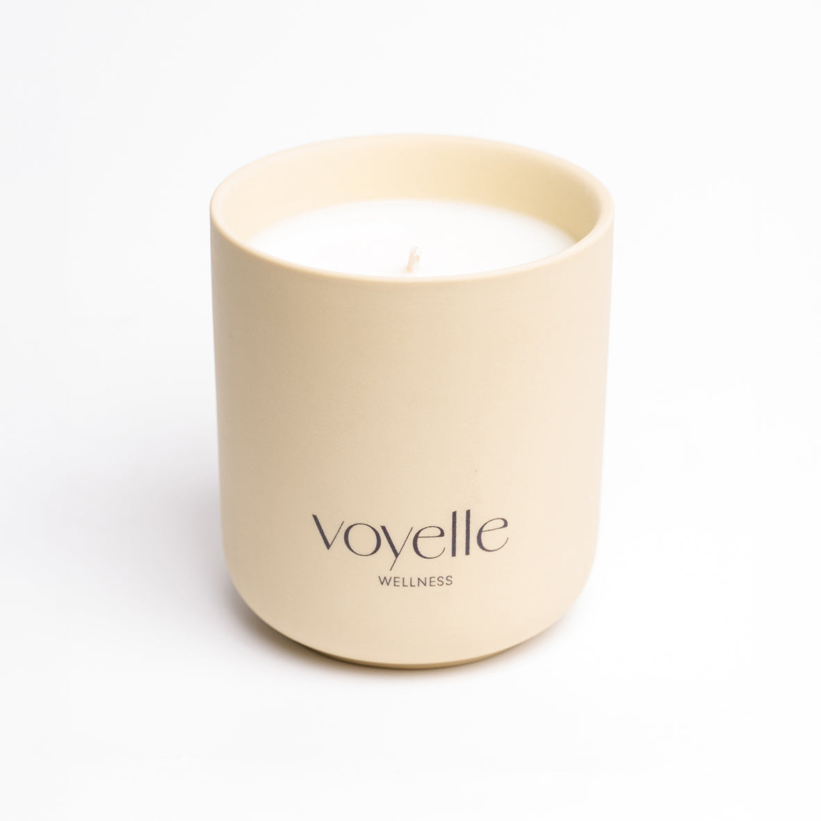 SPA candle in a cream handmade ceramic vessel with the Voyelle logo