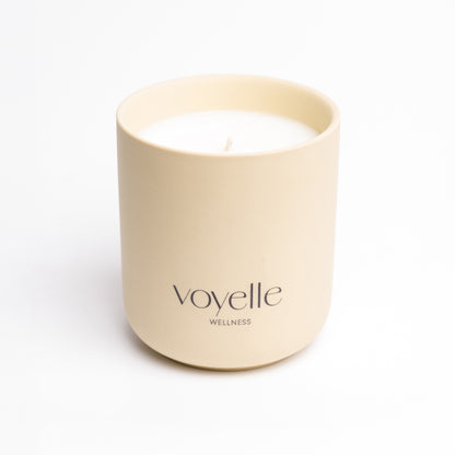 SPA candle in a cream handmade ceramic vessel with the Voyelle logo
