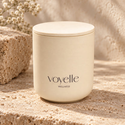 Spicy Romance candle with its wooden lid on travertine stone beside dried gypsophila
